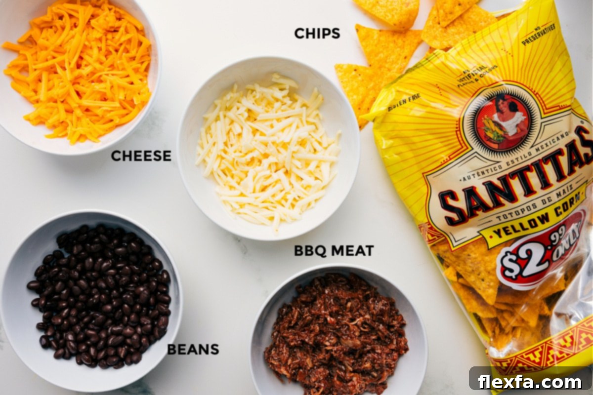 Smoky BBQ Pulled Pork Nachos 3 A beautifully arranged spread of fresh ingredients for Pulled Pork Nachos, including shredded Monterey Jack and Cheddar cheeses, cooked black beans, seasoned pulled pork, and a pile of sturdy tortilla chips, all meticulously prepped for easy assembly.