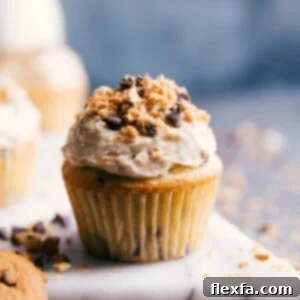 Chocolate chip cupcakes topped with rich icing and sprinkled with chocolate shavings.