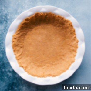 Close-up of a golden graham cracker crust in a pie pan