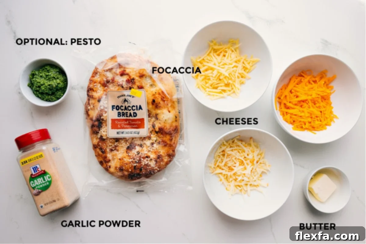 Ingredients laid out for easy assembly: focaccia bread, various cheeses, softened butter, garlic powder, salt, and optional pesto.
