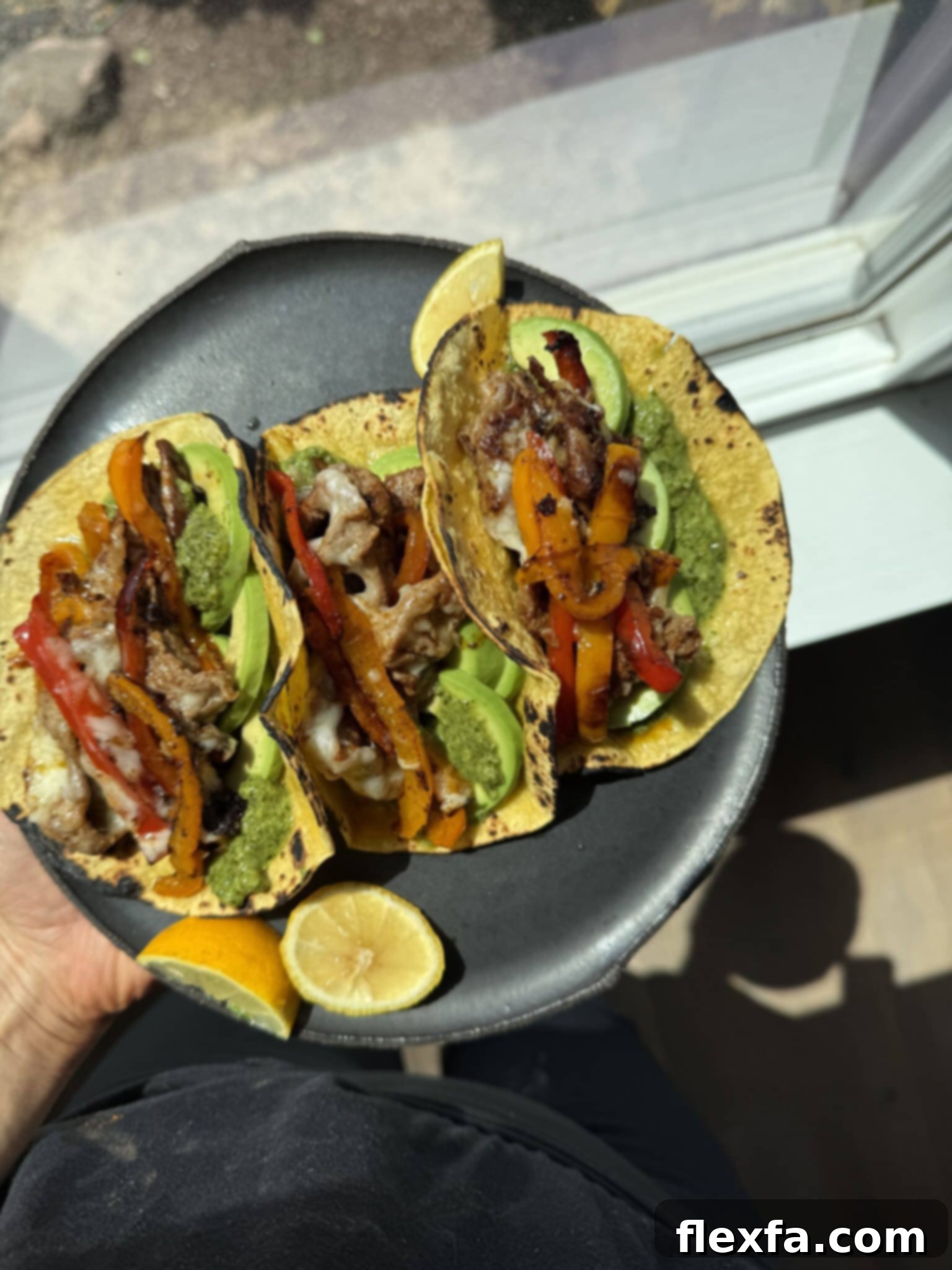 Shaved beef tacos on a plate ready to be enjoyed.