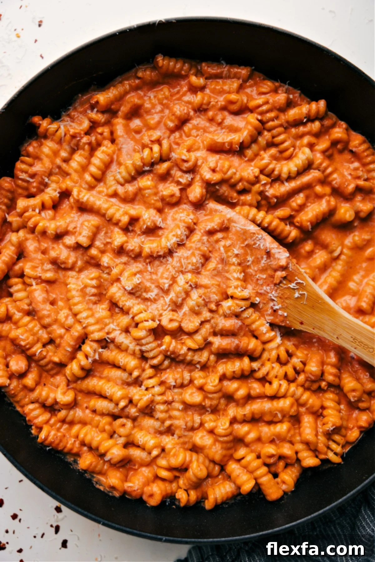 Creamy tomato pasta topped with fresh Parmesan cheese.