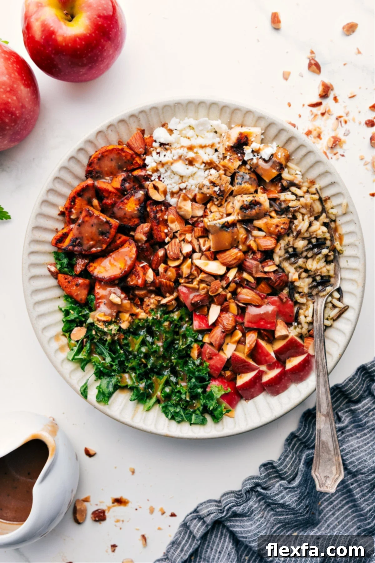 High Protein Chicken Sweet Potato Harvest Bowl Recipe with Balsamic Glaze A vibrant Chicken Sweet Potato Harvest Bowl generously topped with balsamic dressing, showcasing tender chicken, roasted sweet potatoes, fresh kale, and crisp apple slices.