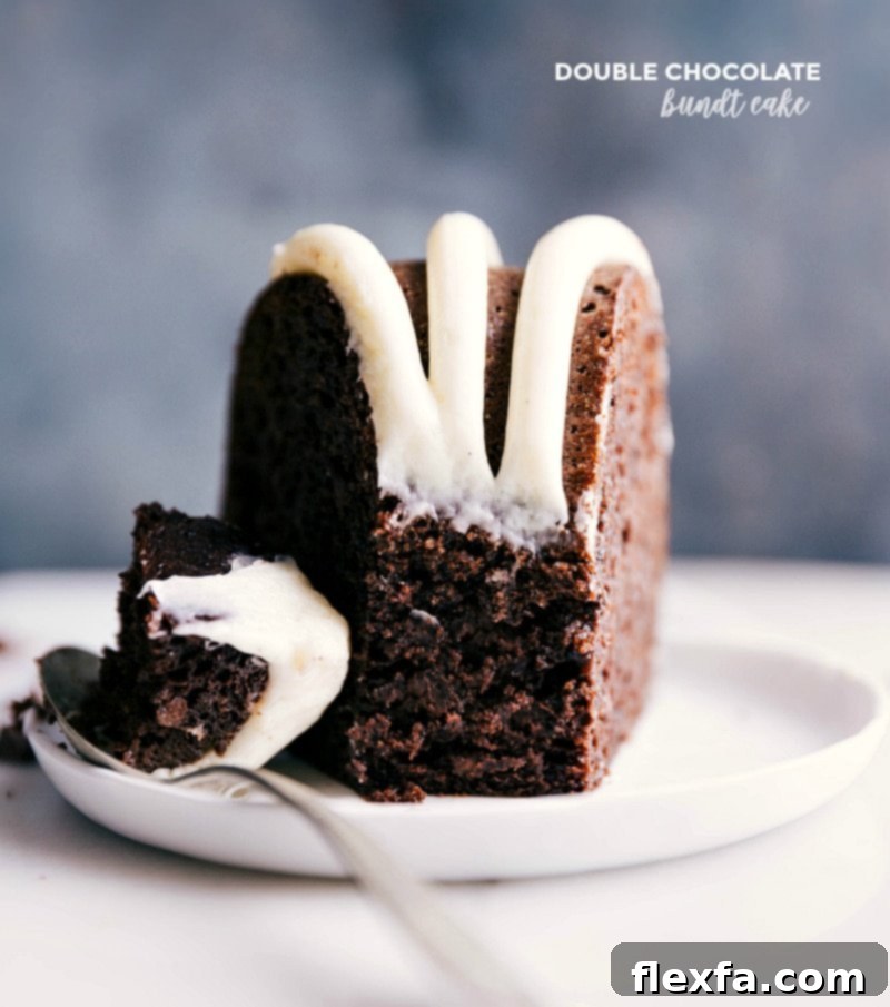 Indulgent Slice of Double Chocolate Bundt Cake with Cream Cheese Frosting Slice of luscious double chocolate bundt cake with a spoonful about to be enjoyed, showcasing its moist texture and rich frosting.