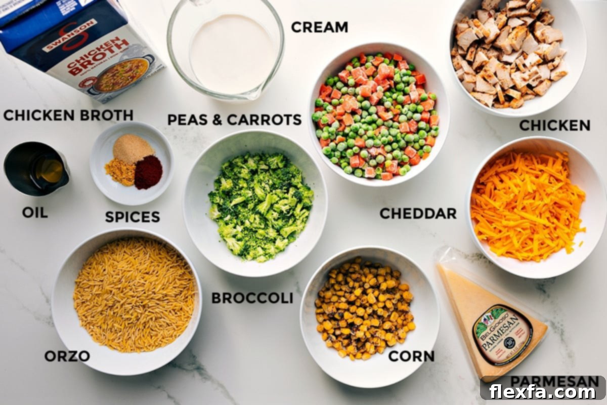 All ingredients meticulously prepped and arranged for making Chicken Orzo Bake. Featured items include chicken broth, heavy cream, olive oil, a variety of spices, frozen peas and carrots, corn, diced cooked chicken, shredded cheddar and parmesan cheeses, and dry orzo pasta.