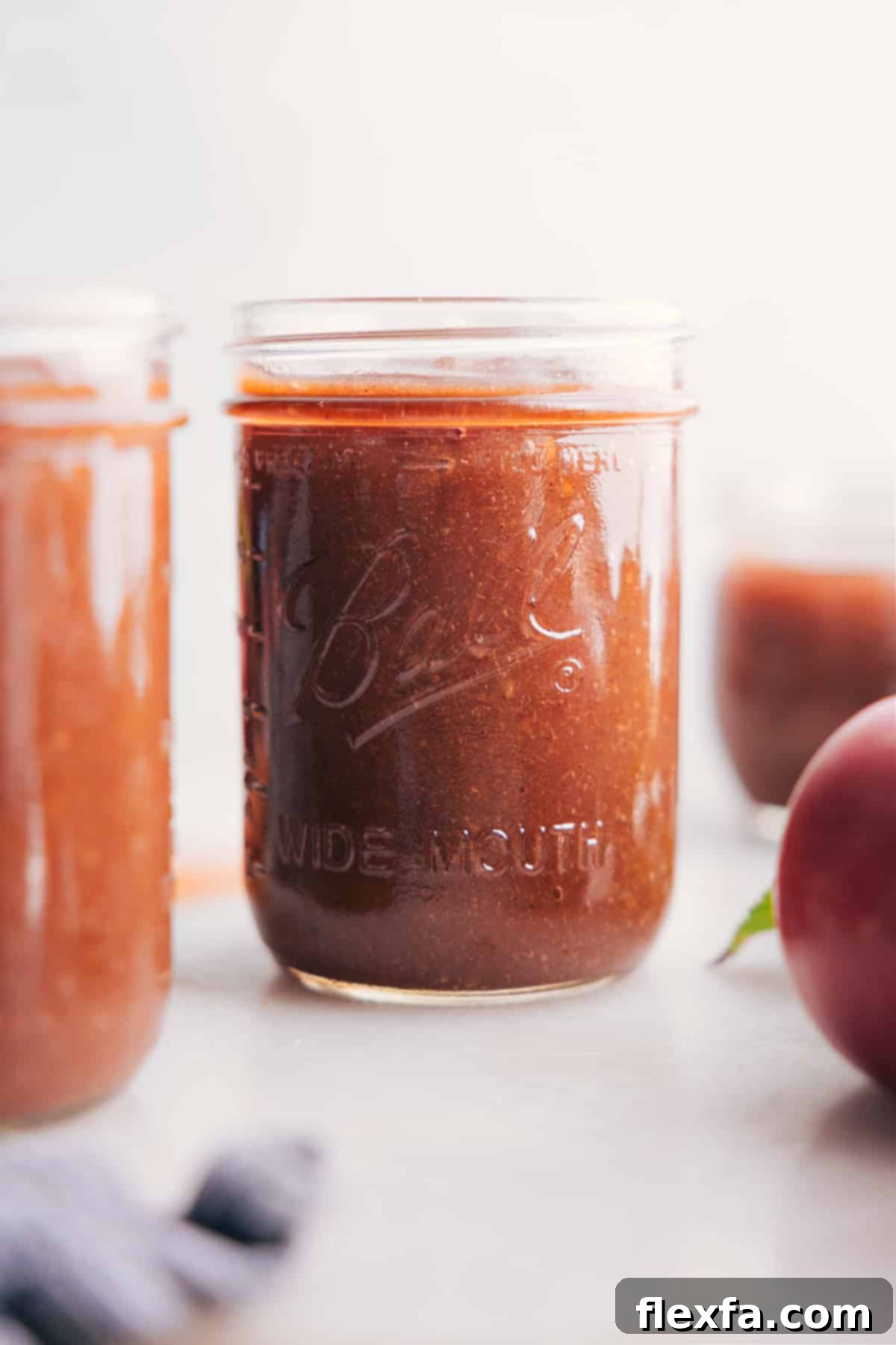 Glass jar filled with rich, smooth Crockpot Apple Butter, ready to be enjoyed.