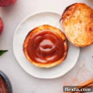 Thick spread of apple butter atop a golden slice of toast.