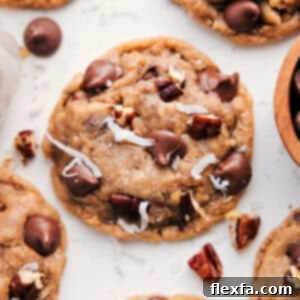 Close-up of a baked Cowboy Cookie with visible oats, chocolate, and coconut.