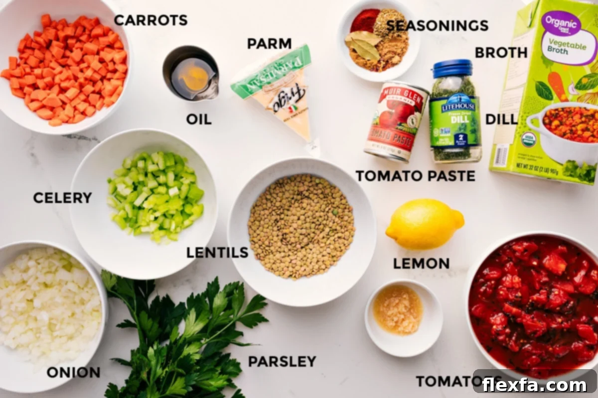 A colorful array of fresh Mediterranean Lentil Soup ingredients prepped and ready: carrots, celery, onion, green lentils, fresh parsley, garlic cloves, diced tomatoes, a lemon, various seasonings, tomato paste, dill, and vegetable broth.