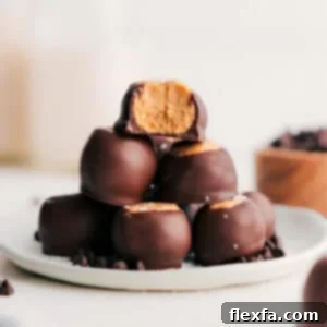 Beautifully arranged, finished Buckeye candies on a white platter, glistening with chocolate coating, ready to be served.