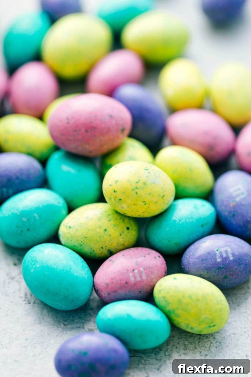 Close up shot of vibrant speckled egg M&M's candies, ready for decorating Easter cupcakes.