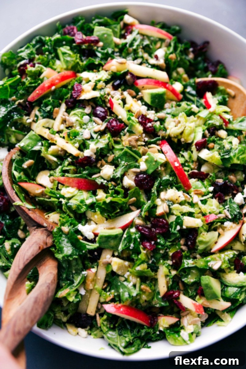 A large bowl filled with freshly tossed Brussels sprout salad, showcasing its rich texture and colorful mix of ingredients, ready for serving.
