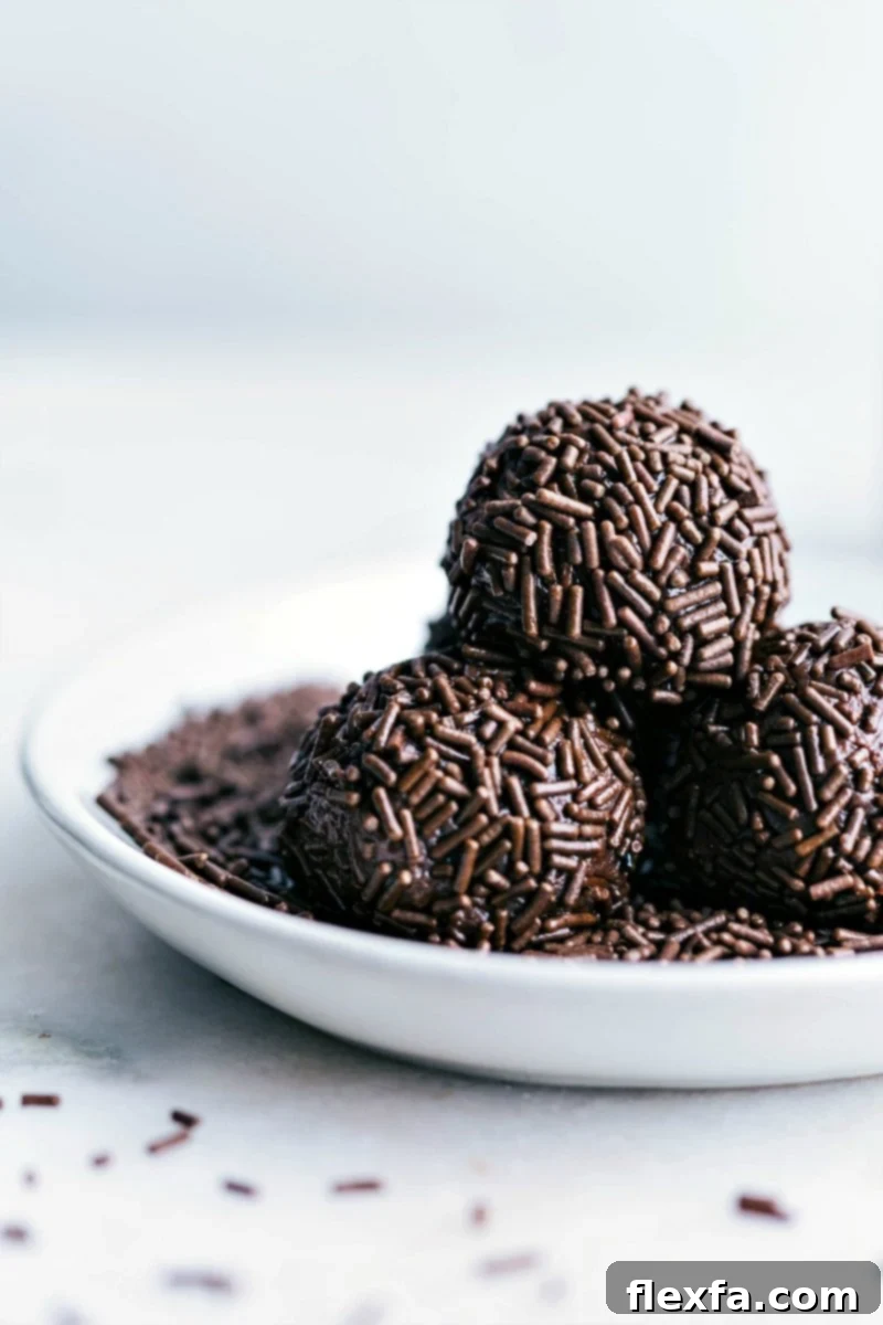 Ready-to-eat chocolate sprinkle-covered Brigadeiros arranged on a plate.