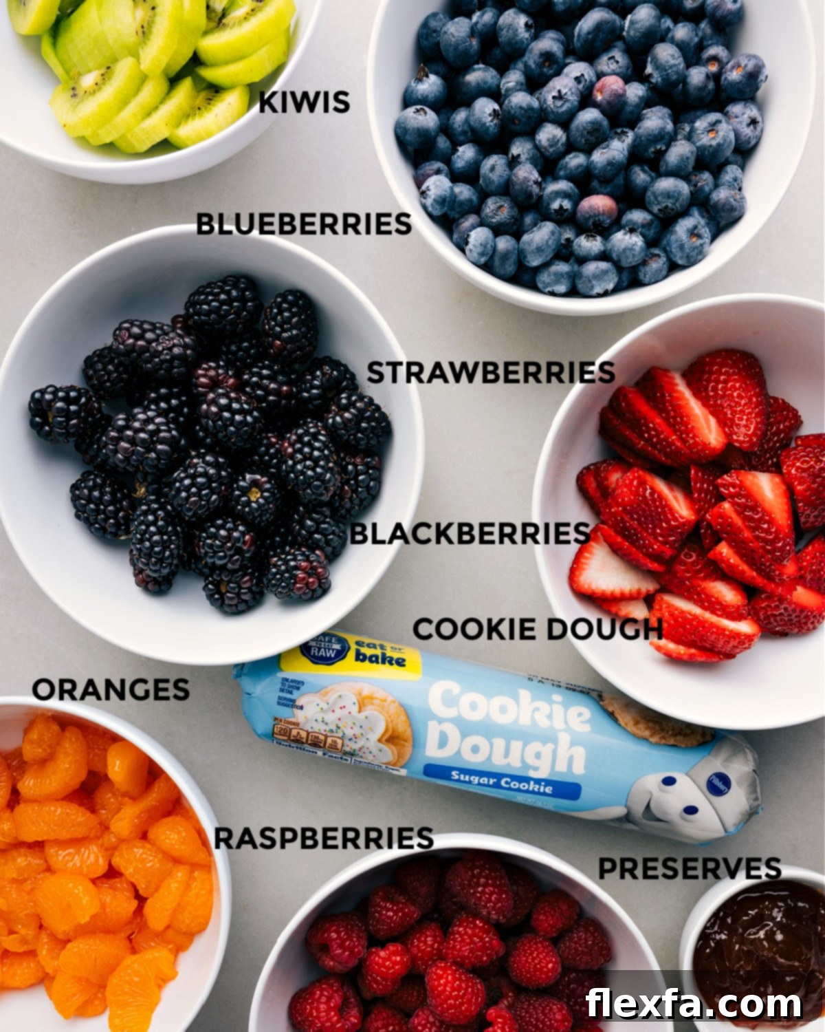 All the vibrant ingredients for a fruit pizza recipe are prepped and ready for easy assembly.