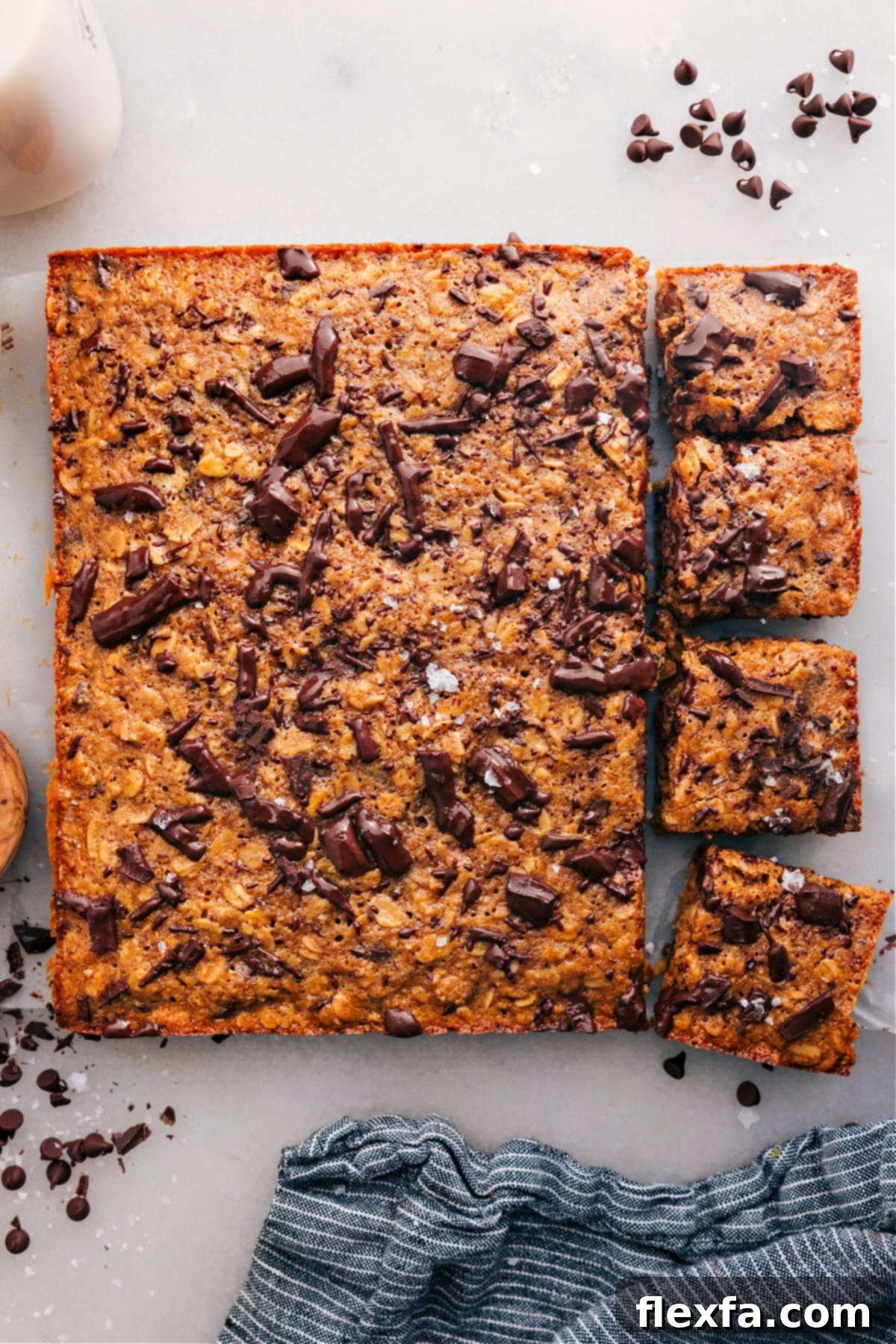 The Best Chewy Soft-Baked Oatmeal Breakfast Bars Delicious Soft-Baked Oatmeal Breakfast Bars with a few squares cut, topped with chocolate, and ready to be enjoyed as a healthy snack or breakfast.