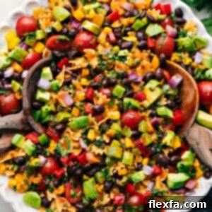 A close-up shot of the vibrant Mexican Pasta Salad, showcasing the mini bowtie pasta, colorful vegetables, black beans, and the zesty chili-lime dressing.
