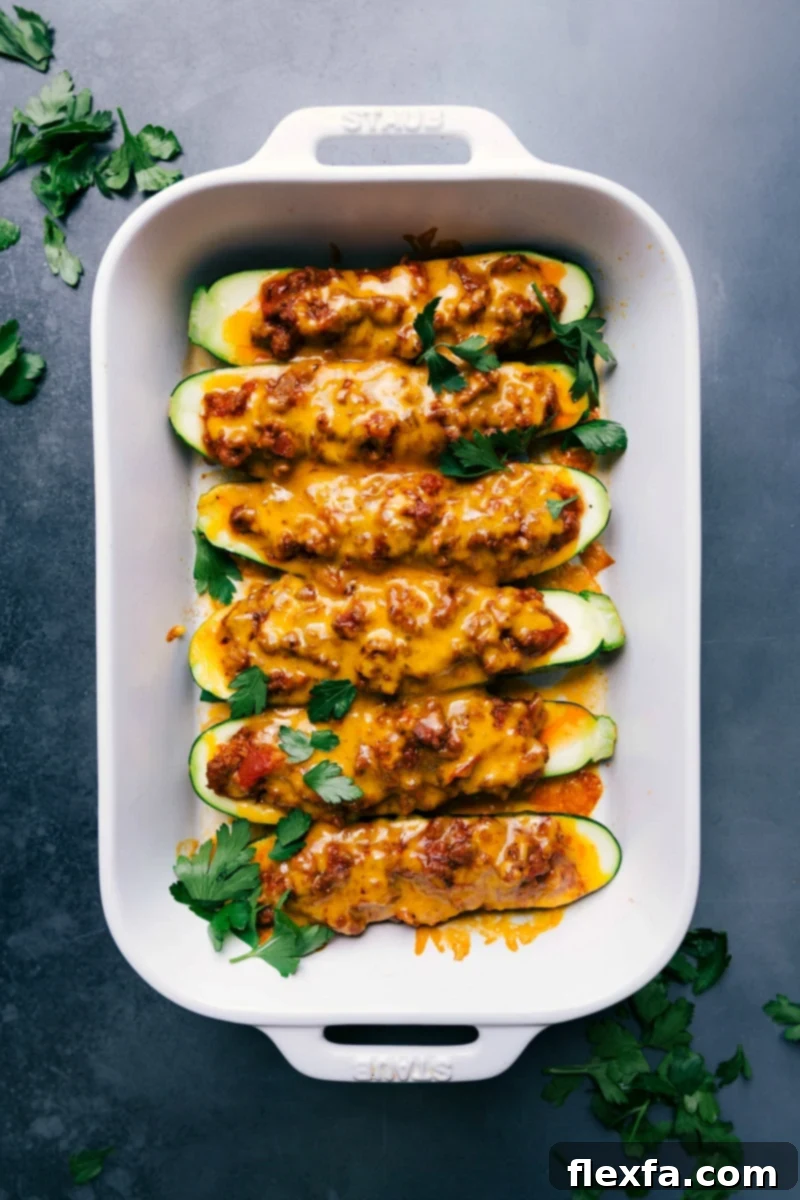 Freshly baked zucchini boats, topped with a delicious meaty sauce and melted cheese, straight out of the oven. A perfect healthy dinner.