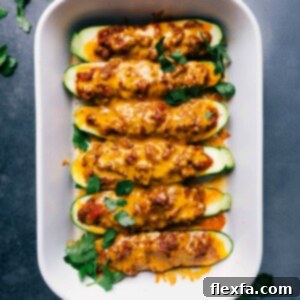 Freshly baked zucchini boats, topped with a delicious meaty sauce and melted cheese, straight out of the oven.