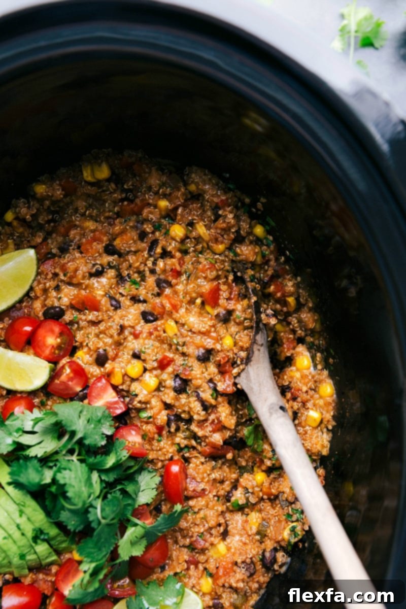 Flavorful Tex-Mex quinoa cooking in a slow cooker, brimming with fresh vegetables and cilantro, ready to be enjoyed.