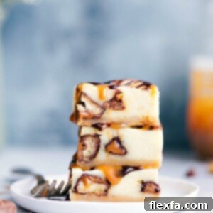Twix Cheesecake Bars topped with caramel and chocolate ganache