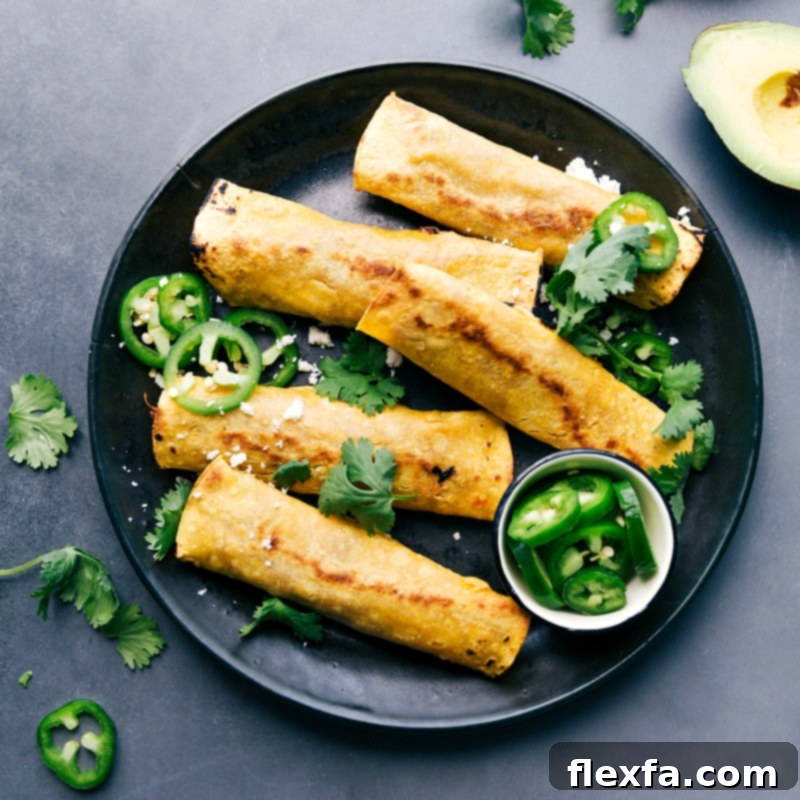 Crispy pork taquitos garnished with fresh cilantro and jalapeños, presenting a flavor-packed meal ready to be enjoyed.
