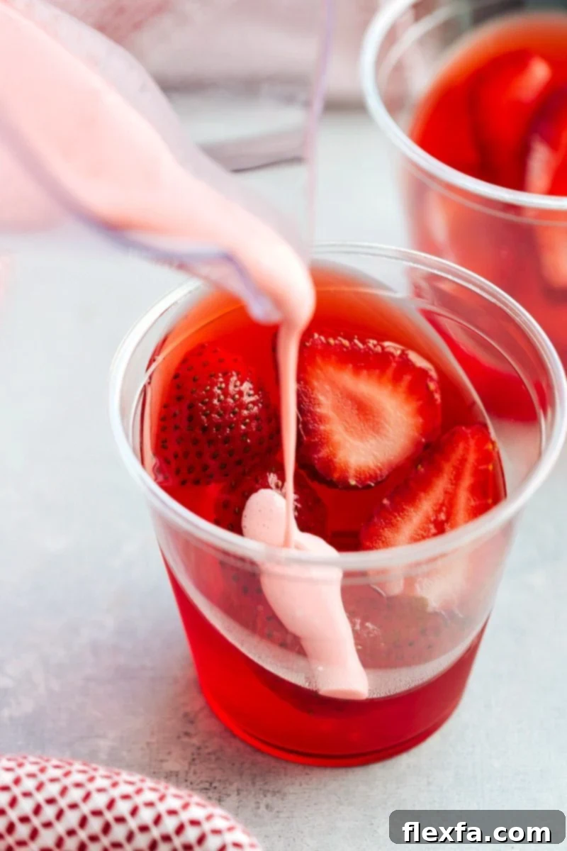 The coolest and easiest hack to make these slanted jell-o parfait cups with a strawberry mousse on top. Delicious and so easy to create!