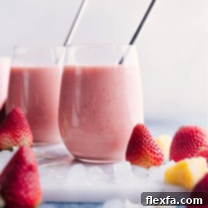 A perfectly blended Strawberry Piña Colada smoothie in a glass, ready to be enjoyed.