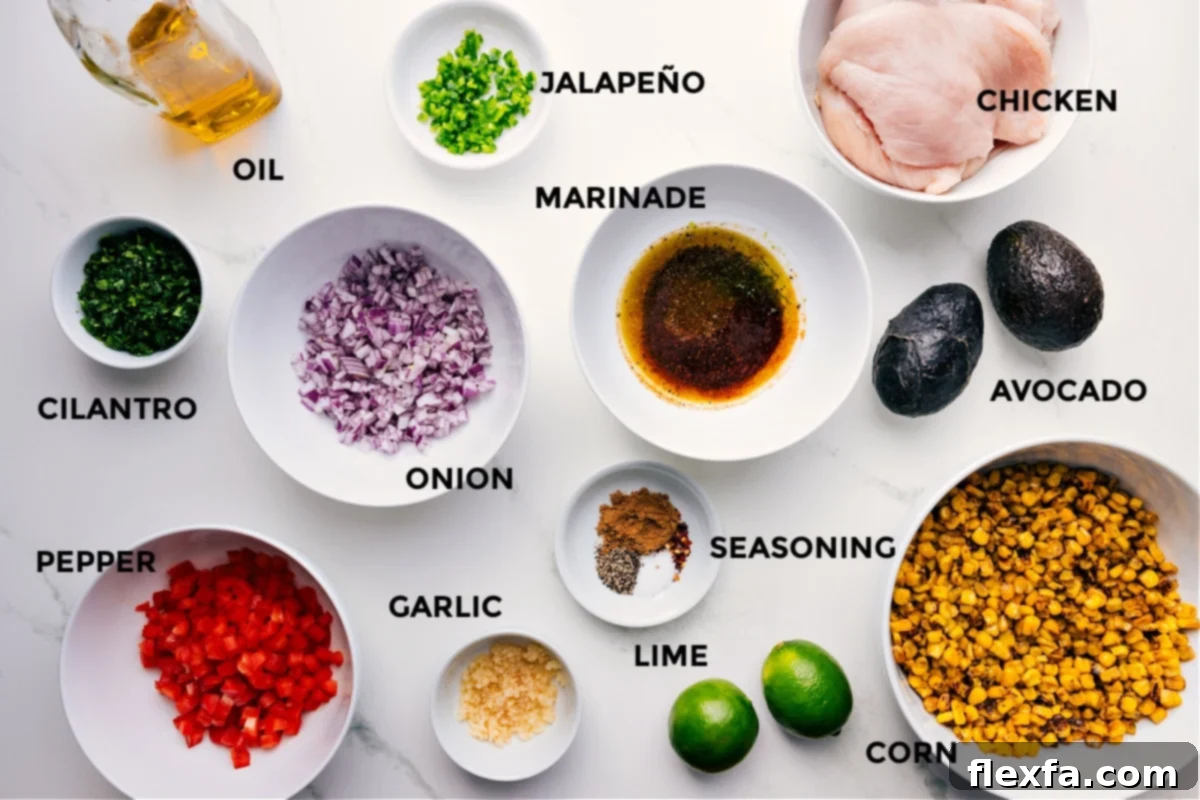 A beautifully arranged selection of fresh ingredients for grilled taco chicken and avocado corn salsa, including marinated chicken, fresh jalapeños, red onion, various seasonings, sweet corn, ripe limes, garlic cloves, red bell pepper, fresh cilantro, and a bottle of olive oil, all ready for preparation.