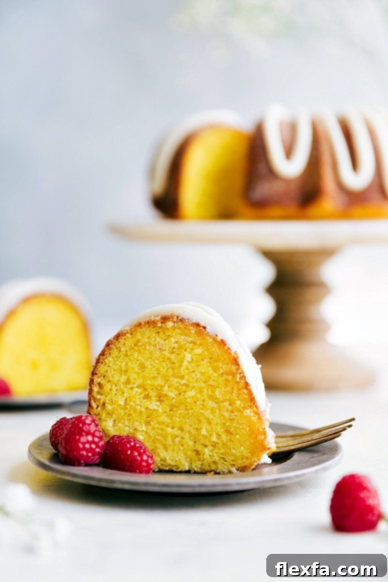 Zesty Lemon Bundt Delight 4 A close-up of a perfectly sliced lemon bundt cake, showing its moist texture and vibrant yellow color, with the lemon buttercream frosting drizzled on top. Ideal for a spring or summer dessert.