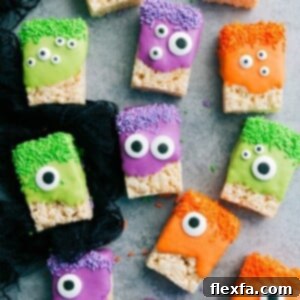 A vibrant green Monster Rice Krispies treat with multiple candy eyeballs, ready to be devoured.