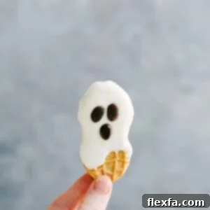 Delightful Nutter Butter Ghost Cookies with white chocolate coating and cute chocolate chip faces.
