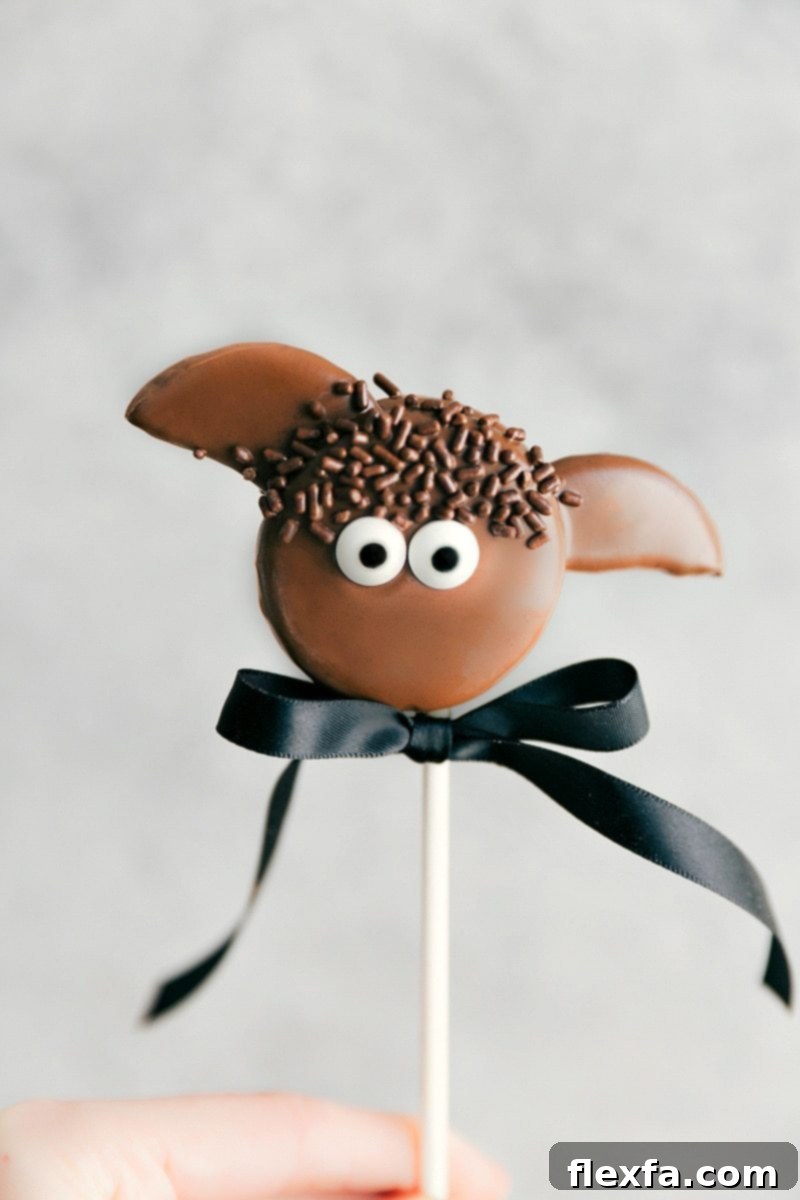 Spooktacular Oreo Pop Treats 2 A festive array of Simple Halloween Oreo Pops: Bat Oreo Pops, Pumpkin Oreo Pops, Mummy Oreo Pops, and Eyeball Oreo Pops, perfect for parties.