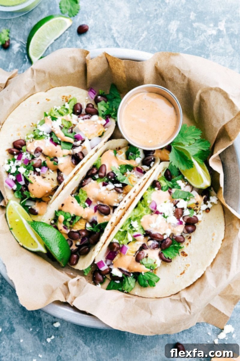 BBQ Chicken Tacos, beautifully assembled with fresh toppings and a tangy BBQ sauce, made from a single rotisserie chicken. A perfect quick, kid-friendly family meal solution.