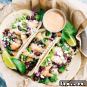 Delicious BBQ Chicken Tacos recipe image, featuring shredded chicken, fresh vegetables, and cheese in soft tortillas.