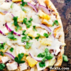 Delicious BBQ Chicken Flatbread recipe image, featuring shredded chicken, cheese, red onion, and pineapple on a crispy flatbread.