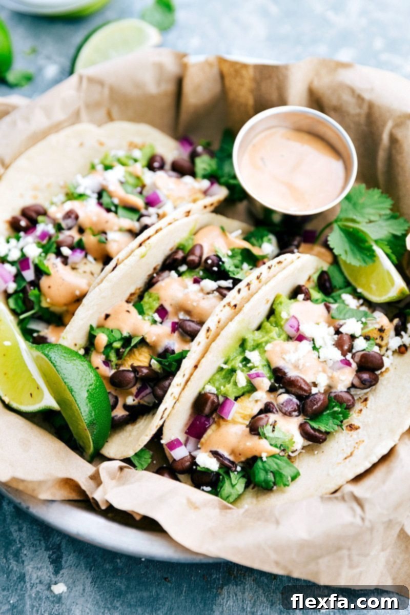 BBQ Chicken Tacos, beautifully assembled with fresh toppings and a tangy BBQ sauce, made from a single rotisserie chicken. Perfect for a quick, kid-friendly family meal solution.