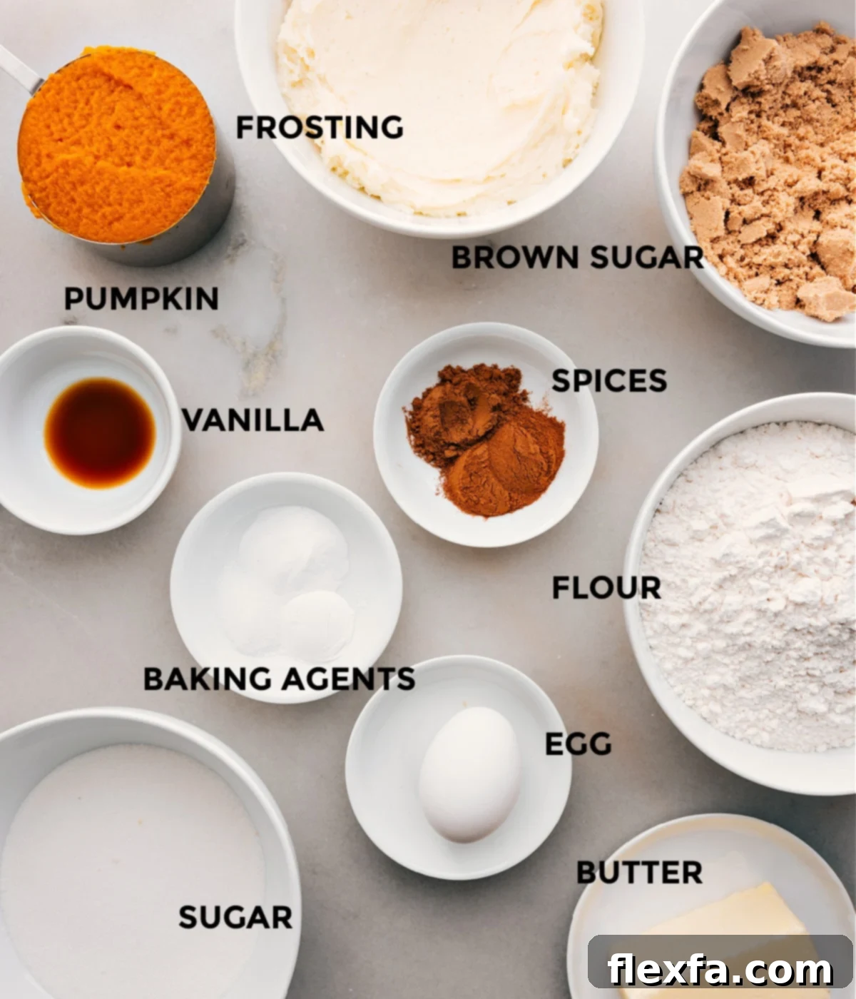 Carefully selected ingredients for Soft Pumpkin Cookies with Cream Cheese Frosting, including sugar, various spices, flour, leavening agents, egg, butter, vanilla extract, and pure pumpkin puree, laid out and ready for baking.