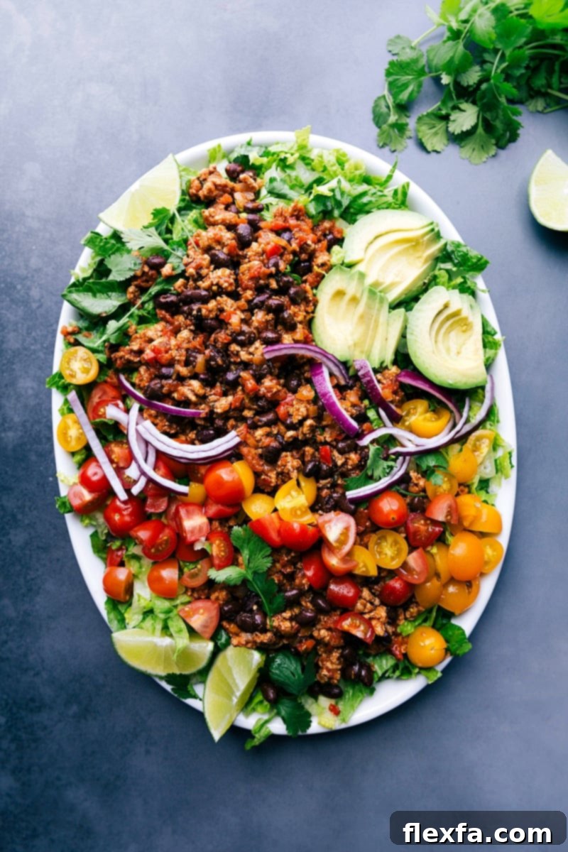 Ground turkey taco salad complete with a variety of fresh ingredients on top.