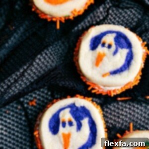 Double-sided Halloween cookies featuring pumpkin and ghost shapes.