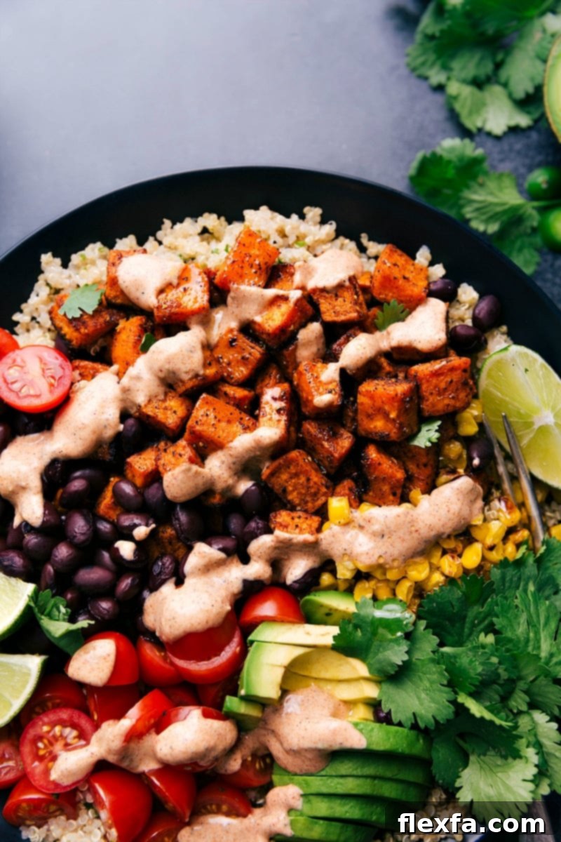 A prepared Sweet Potato Taco Bowl, close-up, showing the variety of toppings and the rich texture of the ingredients.