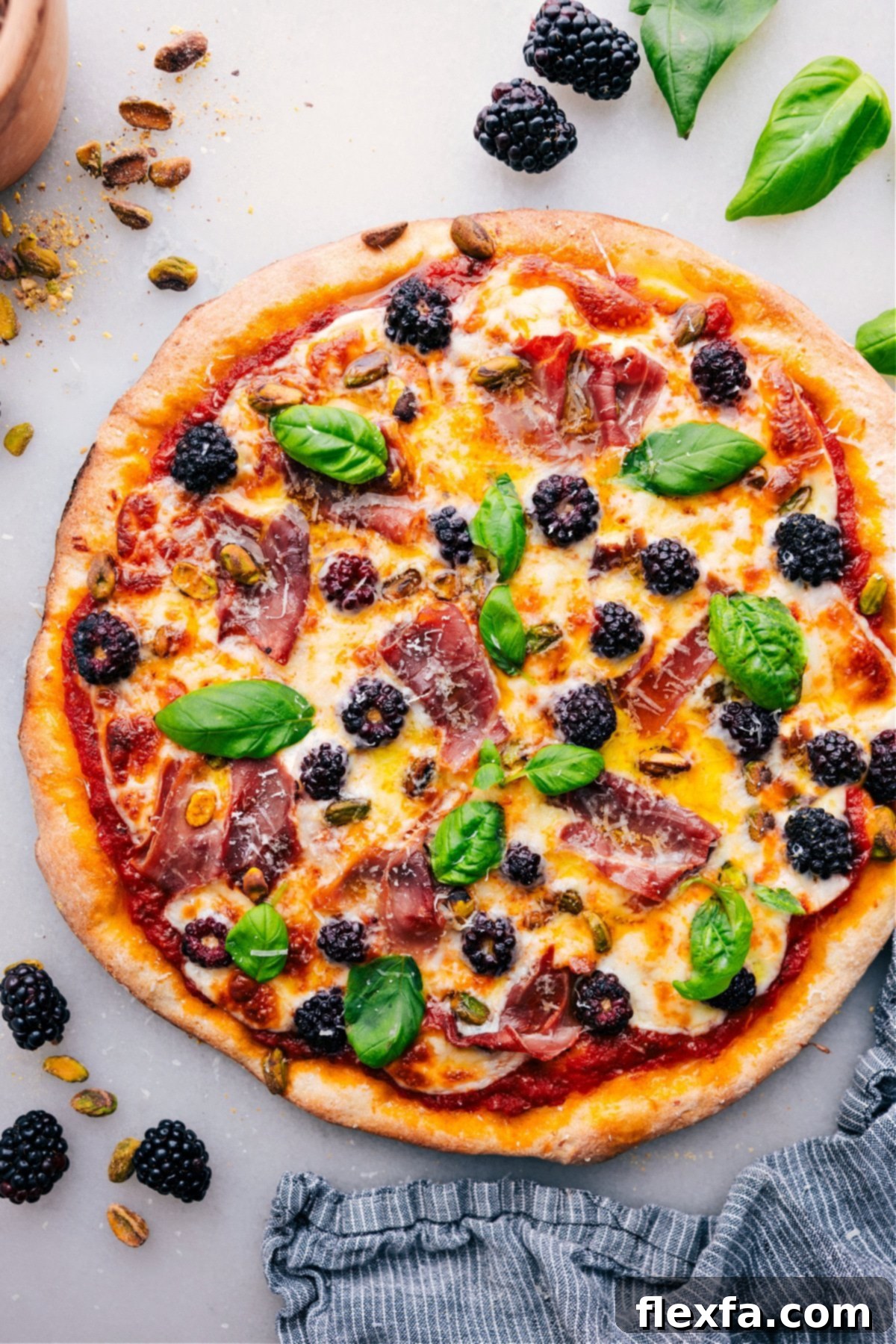 The Best Blackberry Basil Pizza Recipe - A Unique Sweet and Savory Treat Freshly baked Blackberry Basil Pizza, topped with vibrant fresh basil and glistening with a hint of olive oil, ready to be sliced and served.
