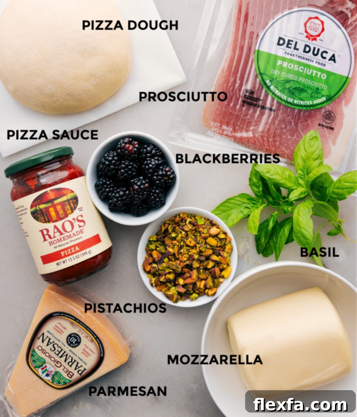 Key Ingredients for Fresh Basil Blackberry Pizza All the essential ingredients for making Blackberry Basil Pizza are neatly prepped and arranged, including a fresh ball of pizza dough, slices of prosciutto, vibrant basil leaves, juicy blackberries, a rich pizza sauce, creamy mozzarella, and crunchy pistachios, all ready for assembly.