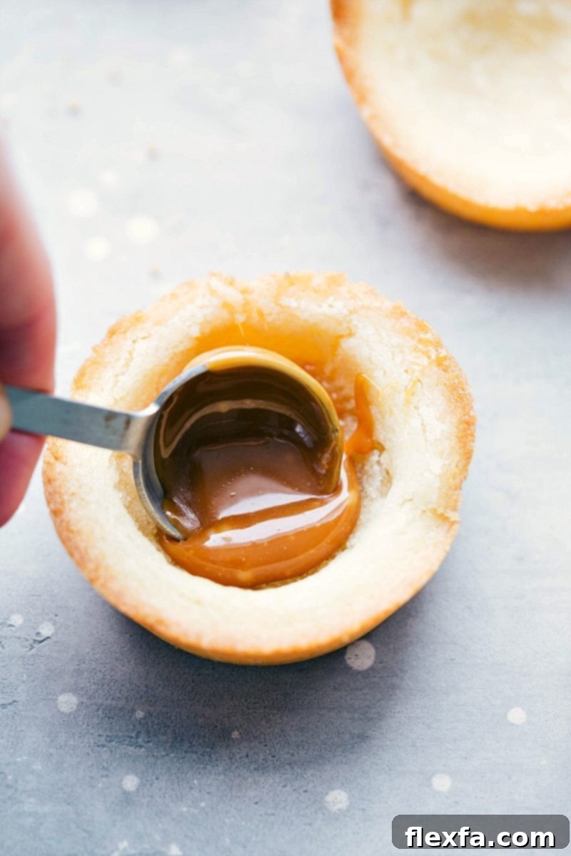Four beautifully presented Sugar Cookie Turtle Pudding Bites on a white plate, showcasing the detailed layers and elegant presentation.