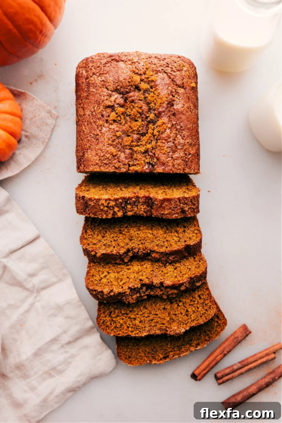 Perfect Pumpkin Bread Loaf - Sliced and Ready to Enjoy A beautifully baked loaf of moist pumpkin bread, with several slices cut and arranged, ready to be enjoyed. The interior shows a tender crumb and hints of warm spices.