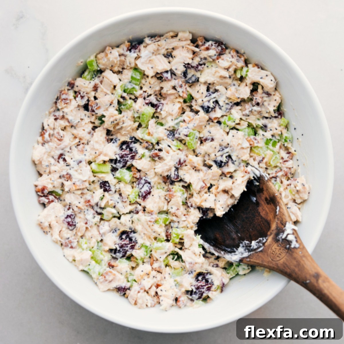 The Best, Easy Chicken Salad Recipe The perfectly combined chicken salad in a serving bowl, ready to be presented in various ways – nestled in fresh lettuce, on soft bread, or simply as a dip.