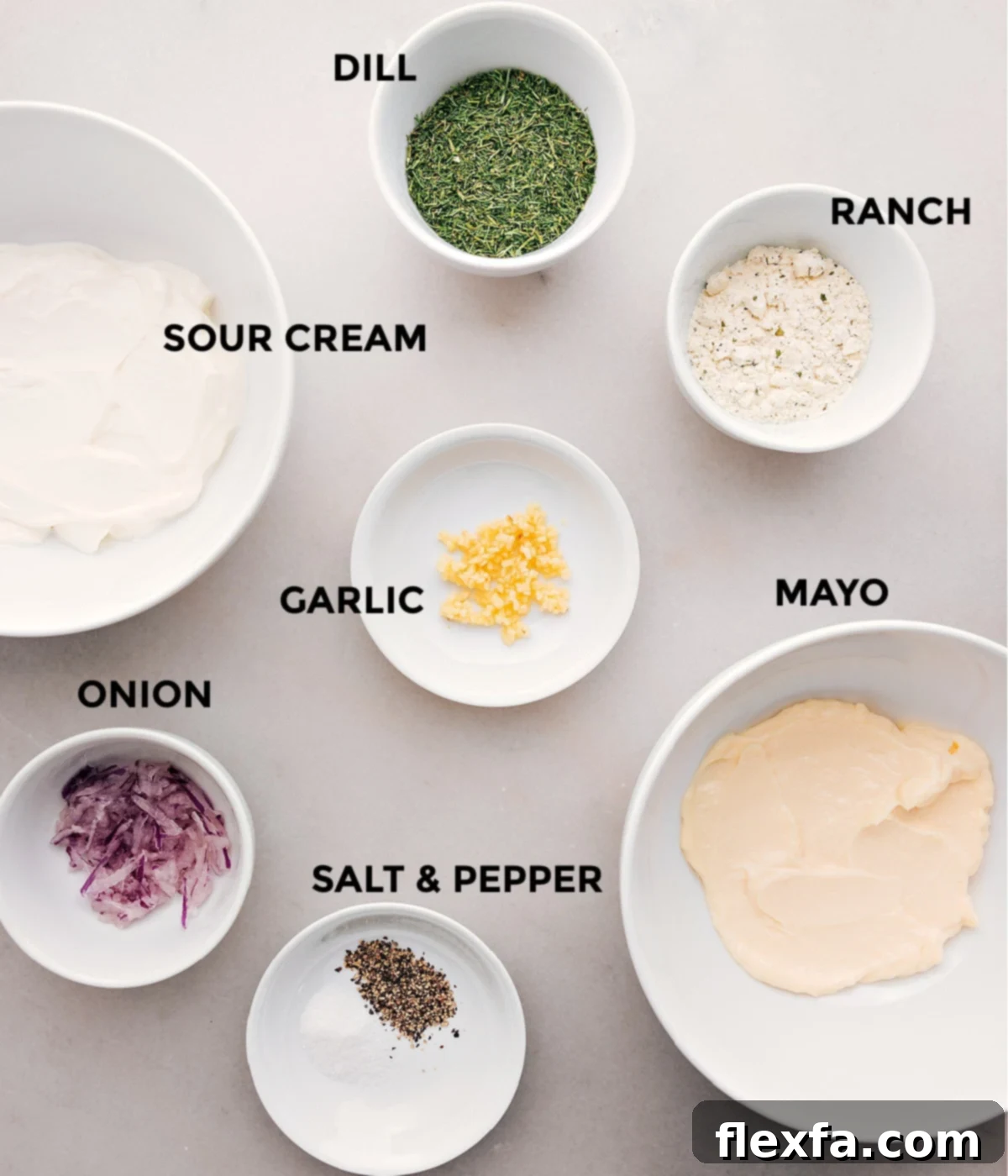 All the essential ingredients for creating a creamy, tangy, and flavorful homemade veggie dip are meticulously laid out on a clean kitchen surface. These include a tub of rich sour cream, a jar of smooth mayonnaise, a packet of savory ranch seasoning mix, a small bowl of fresh or freeze-dried dill, finely minced garlic cloves, delicately grated red onion, and a sprinkle of salt and freshly ground black pepper, all prepped and ready for seamless assembly.