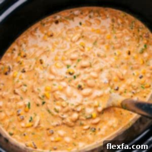 Creamy Crockpot White Chicken Chili in a bowl with toppings