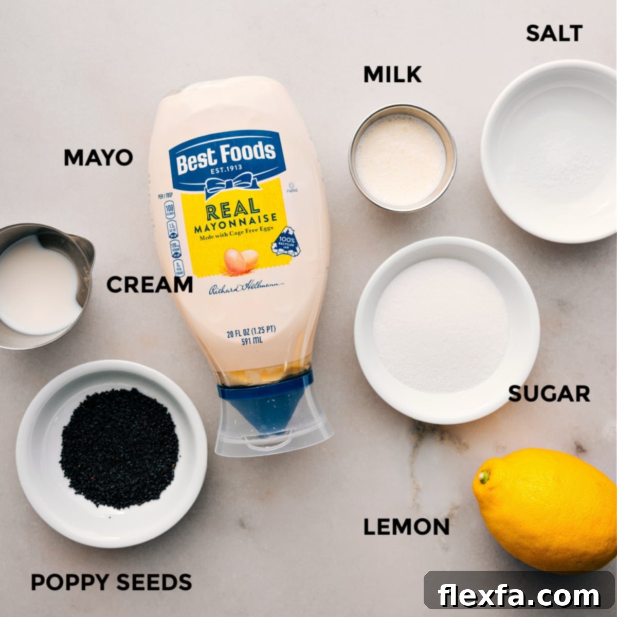 The individual ingredients for the creamy poppyseed dressing are arranged, including mayonnaise, cream, sugar, lemon, milk, salt, and poppyseeds, ready for blending.