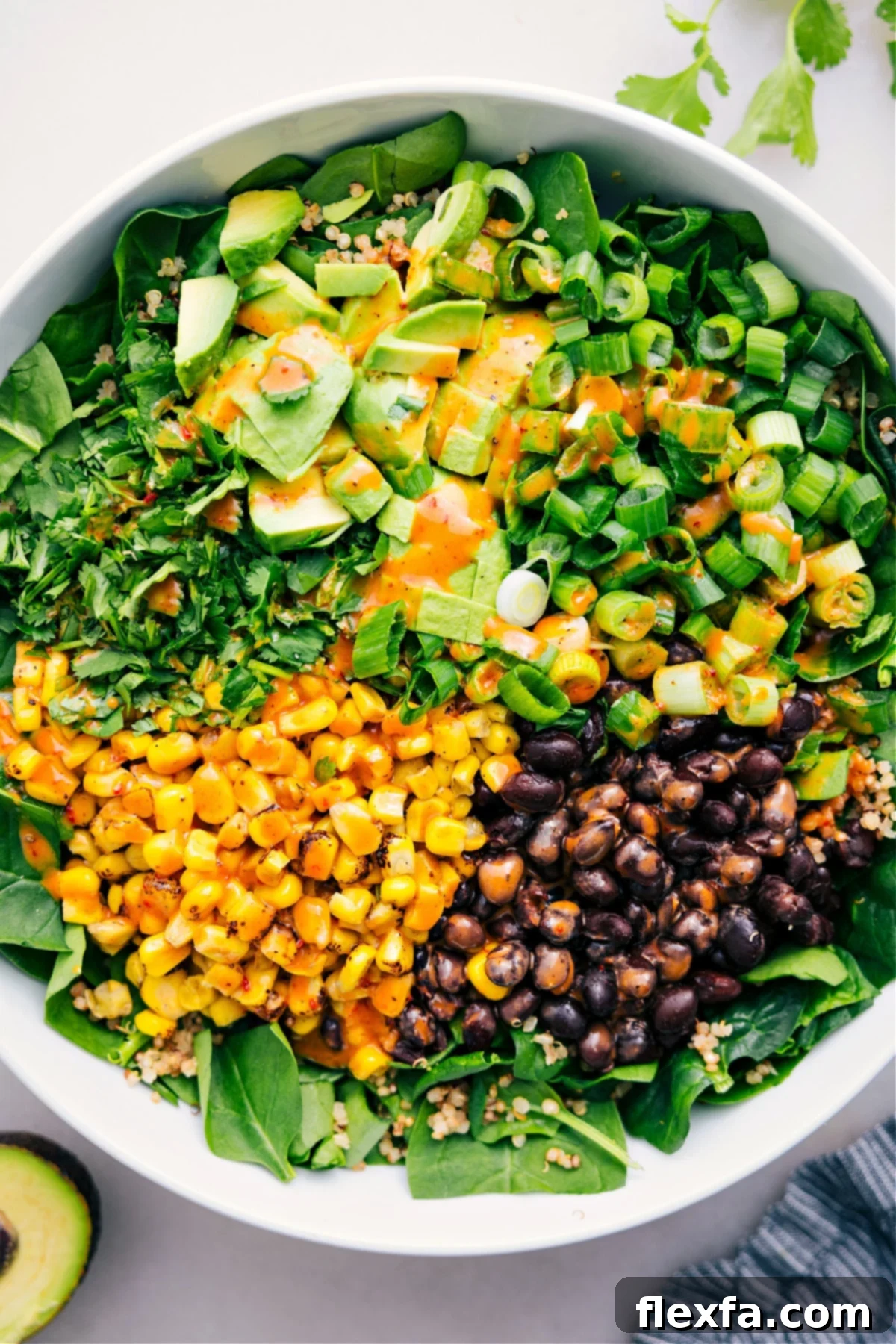 Vibrant Quinoa Corn Salad in a bowl with a drizzle of spicy chipotle-lime dressing, ready to be served.