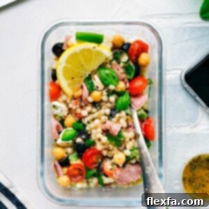 A top-down view of the prepared Italian Couscous Salad in a serving bowl, showcasing its vibrant colors and textures.